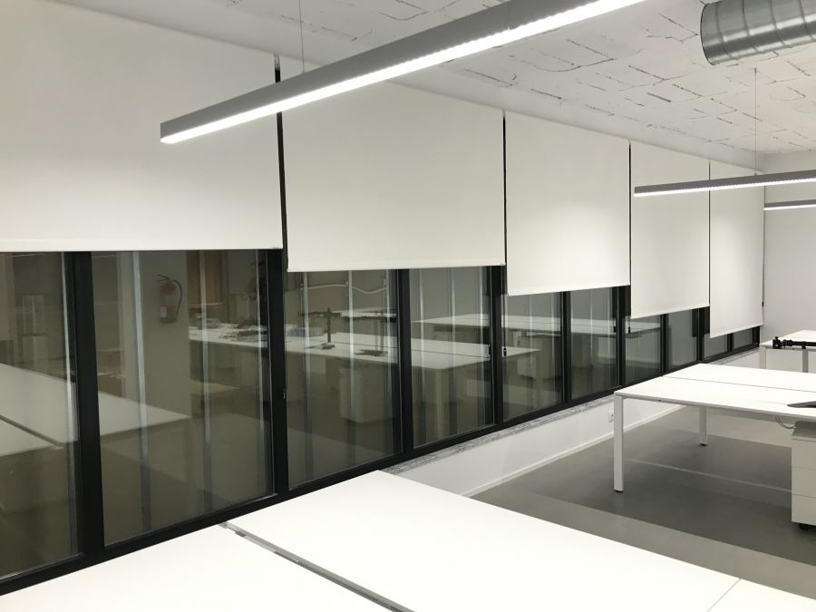 Cortinas enrollables de color blanco, con tejido técnico screen en oficinas de la Travesera de les Corts de Barcelona
