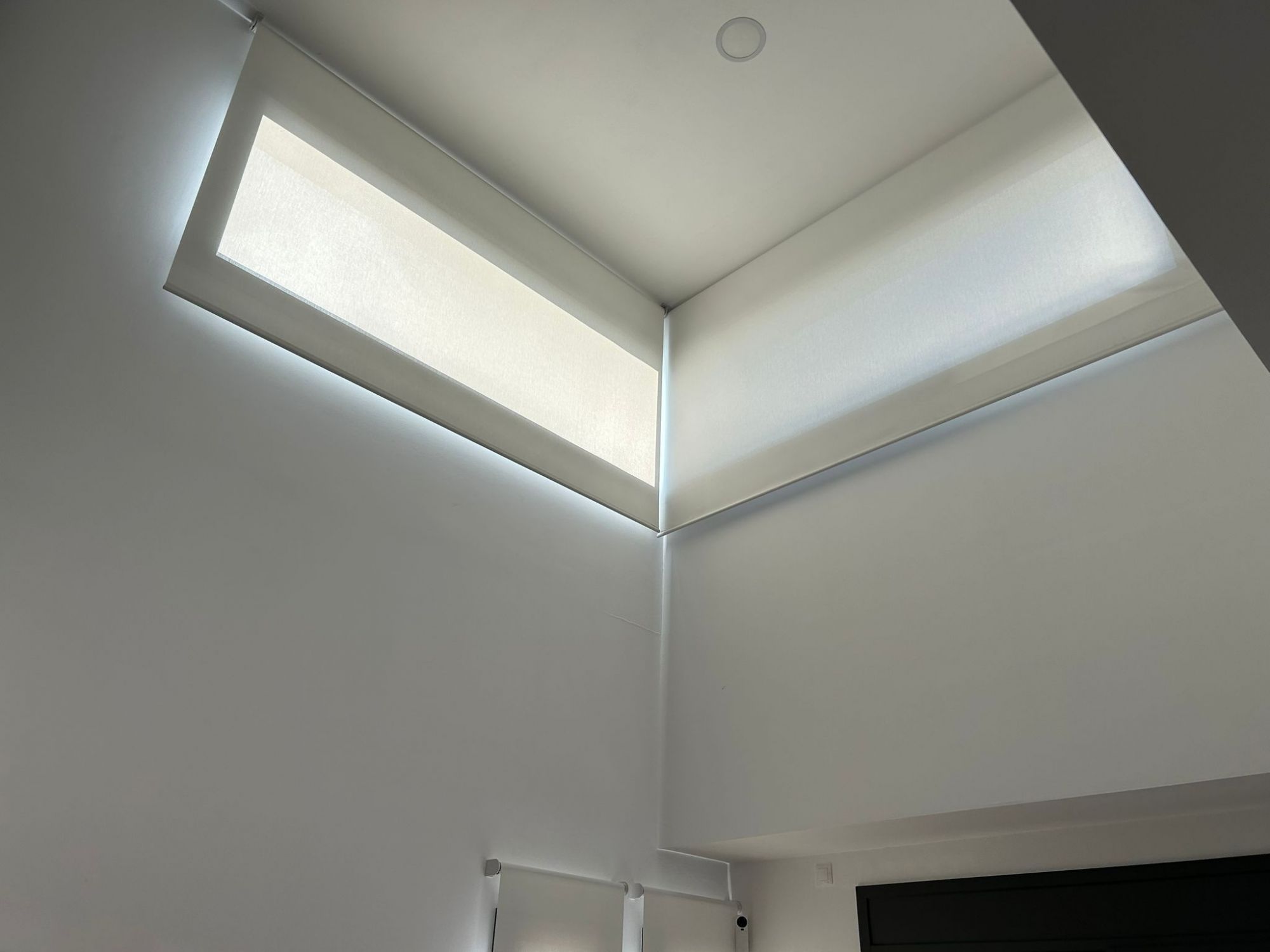 Instalación de cortinas enrollables con tejido técnico screen y motor batería, referencia 420P abertura del 1% y color White, en vivienda de Viladecavalls