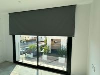 Instalación de cortinas enrollables motorizadas con tejido opaco, referencia Darktex y color Dark Grey 010, en vivienda de Montgat