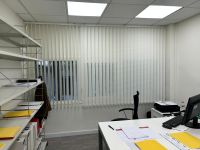 Instalación de cortinas verticales con tejido técnico screen y lamas de 89mm, referencia WOW White y abertura del 10%, en oficinas de Barcelona