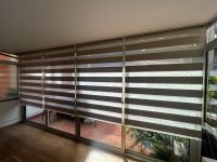Instalación de cortinas NEOLUX sin cajón, terminal Pocket y color Miami ivory, en vivienda de Barcelona